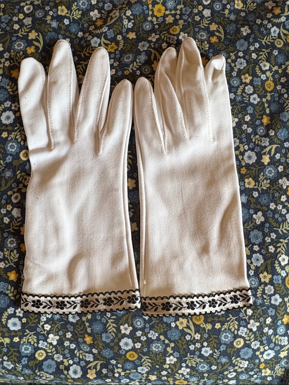 Vintage white gloves with black flower detailing at bottom
